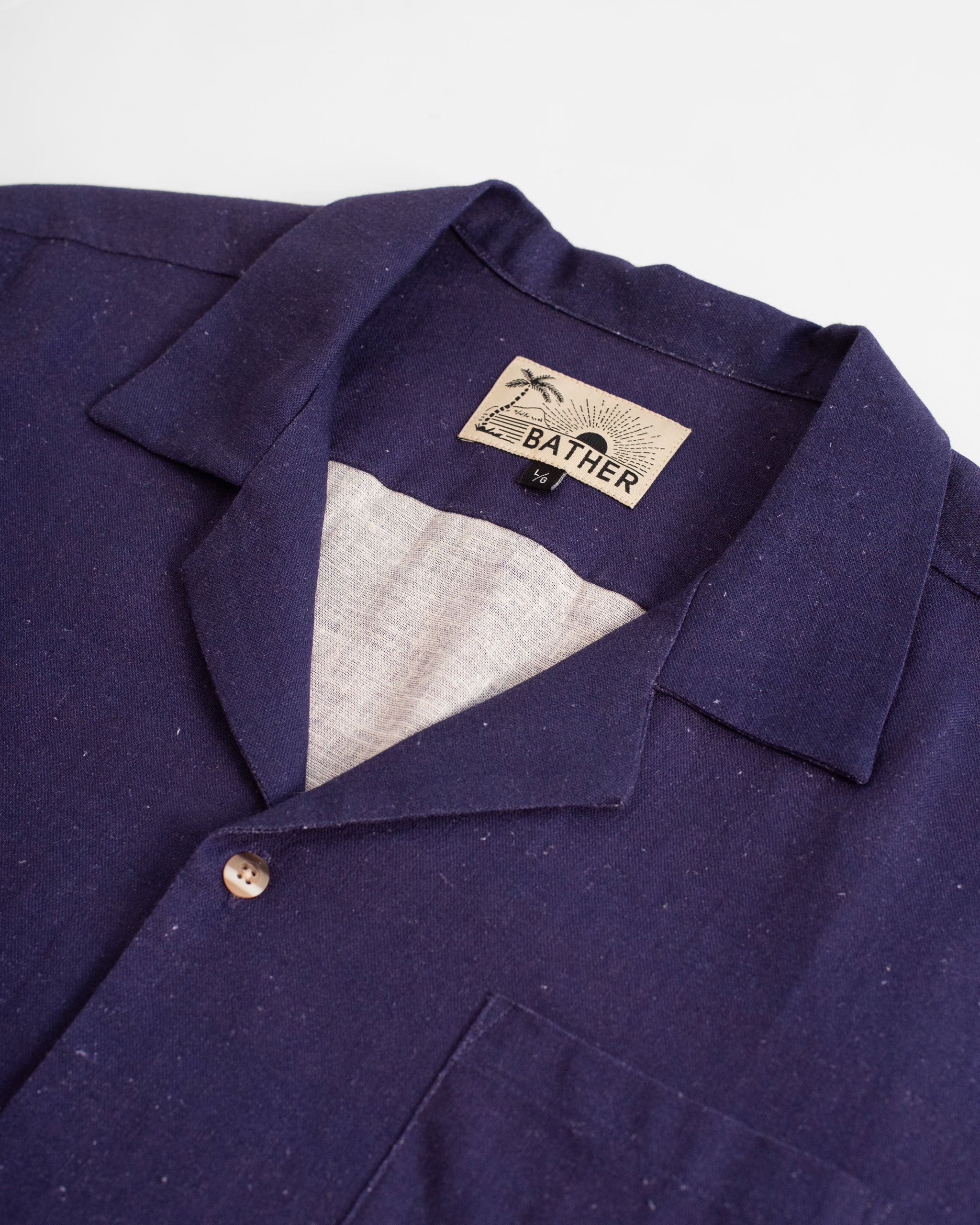 collar close up of Indigo linen camp shirt with floral pattern on the bottom and the sleeves