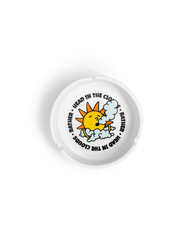 ceramic Bather ashtray with a sun and clouds graphic in the middle 